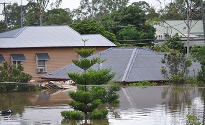 Adove Stock: By kevin davies Floods inundating several homes with only the roof tiles visible of the one in the centre of the picture